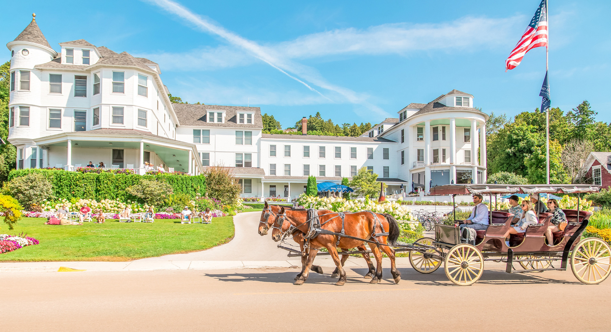 island house hotel with horses in front