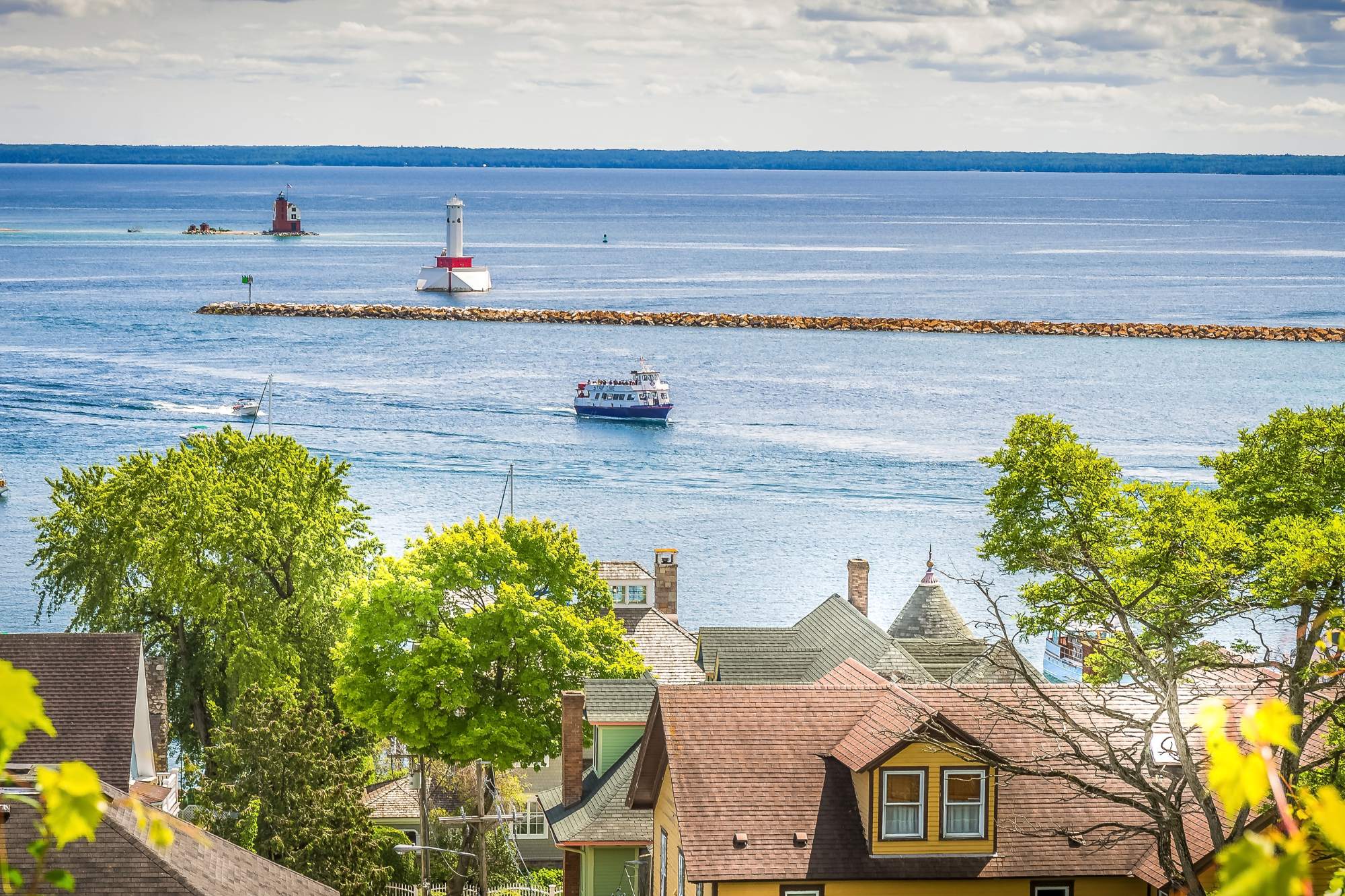 A view of Pine Cottage with Round Island Lighthouse and the Straights of Mackinac in the distance.